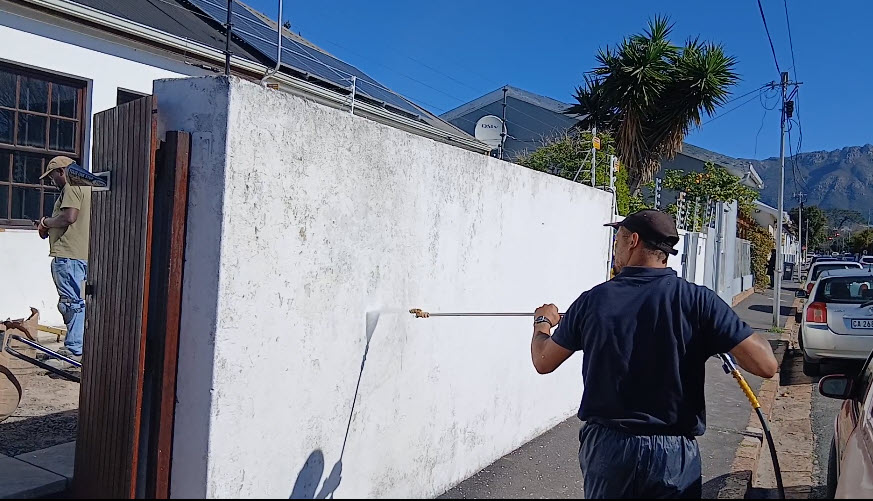 Boundary wall before repainting — faded and stained